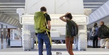 Airport passengers looking at art